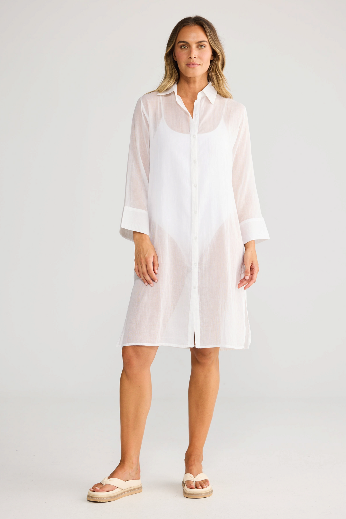 Model wearing ELSHAM BOUTIQUE white cotton shirt dress with concealed button front and short sleeves