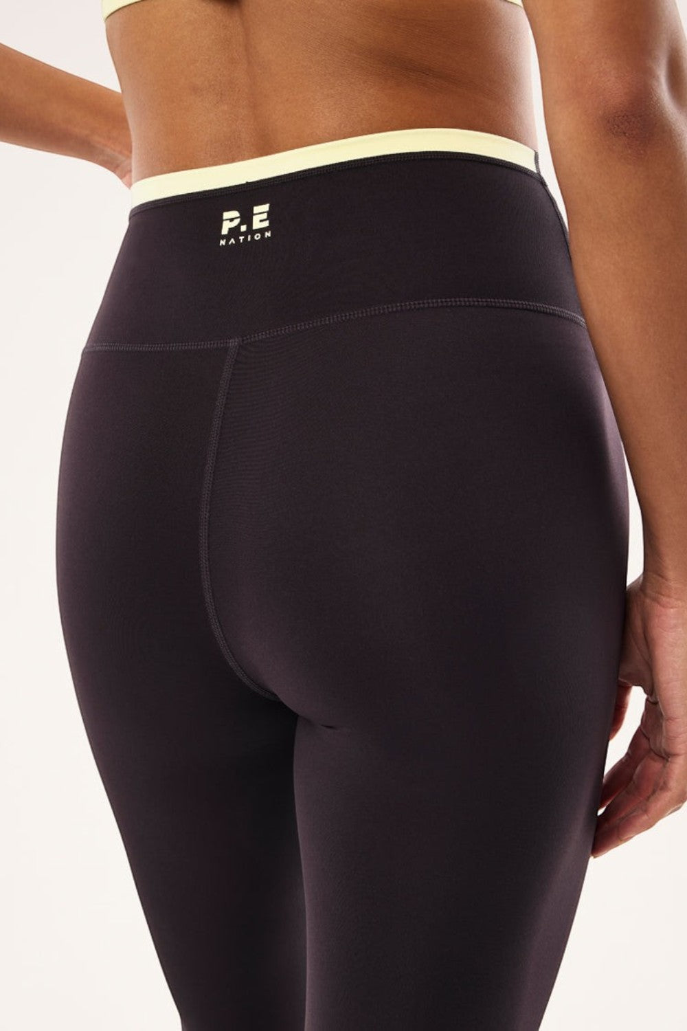 ELSHAM BOUTIQUE Vita full length leggings in black bean with soft yellow high-rise waistband and P.E Nation logo