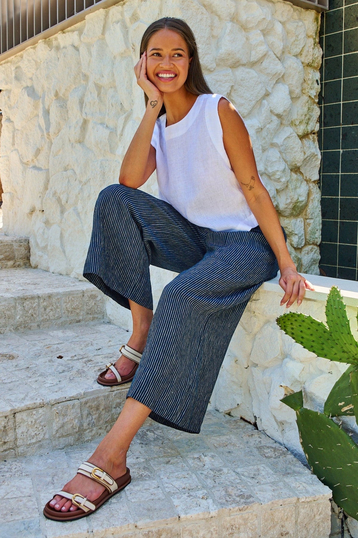ELSHAM BOUTIQUE model wearing navy pinstriped linen wide-leg cropped pants with an elasticated waist and pockets.
