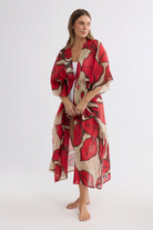 ELSHAM BOUTIQUE Asta long cotton kaftan in crimson floral print with an adjustable waist tie on a model