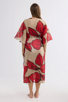 ELSHAM BOUTIQUE Asta long cotton kaftan in beige with a crimson floral print, shown from the back.