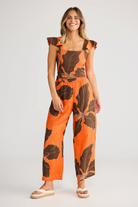 ELSHAM BOUTIQUE Zaria Top in Hibiscus Breeze orange linen gauze with square neckline and ruffle sleeves on a model