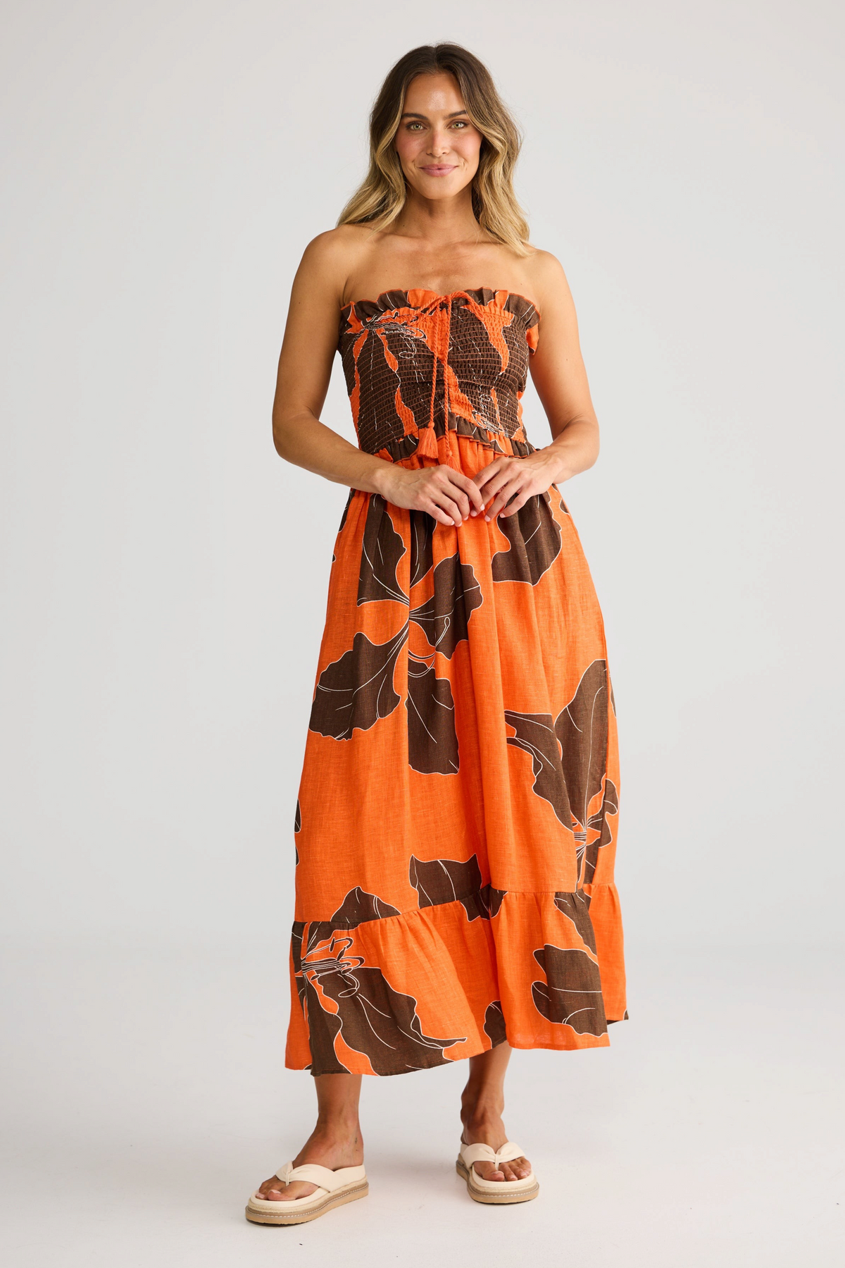 ELSHAM BOUTIQUE Sorrel strapless linen midi dress in orange and brown floral print with rouching and frill details.