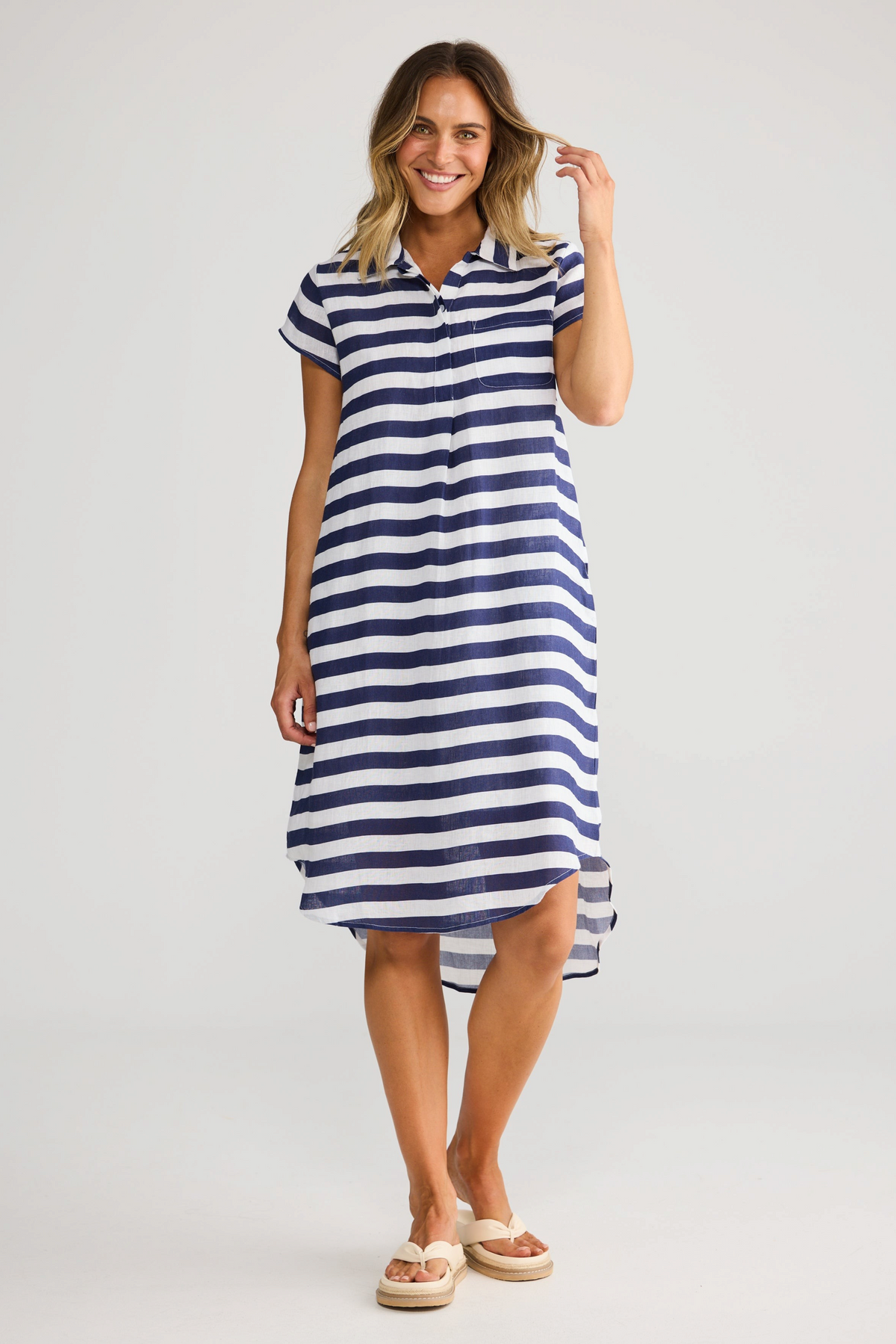 Model wearing ELSHAM BOUTIQUE navy and white striped cotton tunic with collared neckline and hi-lo hemline