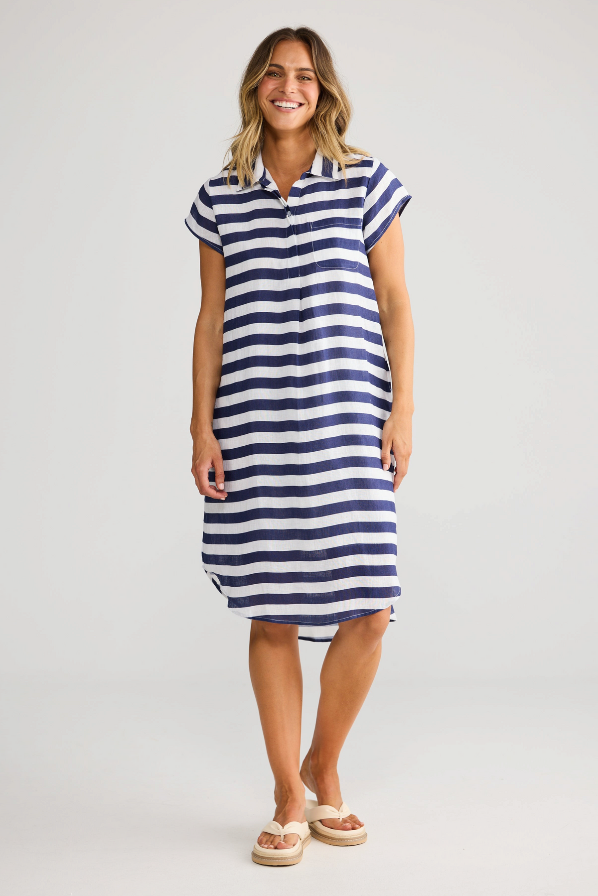 ELSHAM BOUTIQUE navy and white striped cotton tunic with a collared neckline, cap sleeves, and a hi-lo hemline.