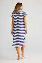 ELSHAM BOUTIQUE navy and white striped cotton tunic with cap sleeves and hi-lo hemline worn by a woman, back view