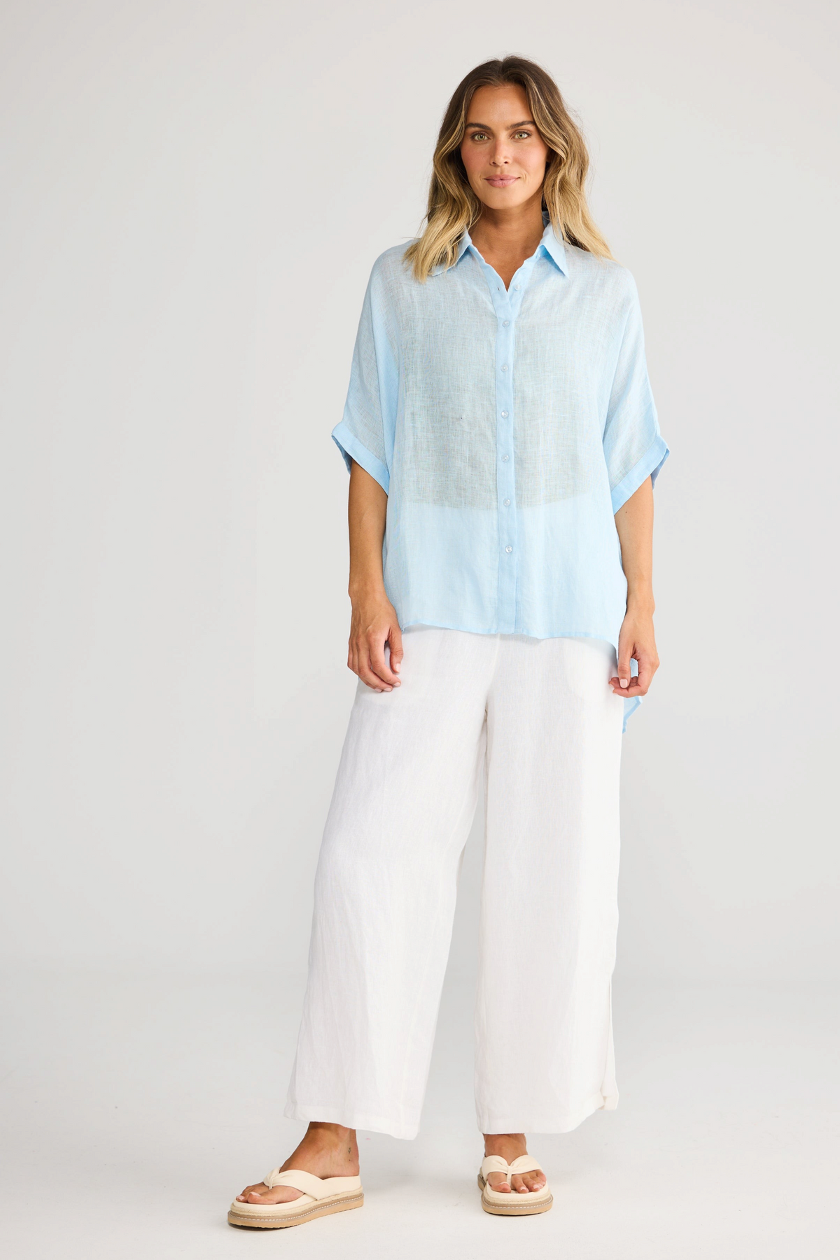 ELSHAM BOUTIQUE light blue linen oversized shirt with collared neckline and short sleeves on a model