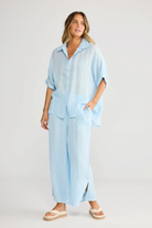 ELSHAM BOUTIQUE light blue oversized linen shirt and matching wide-leg trousers worn by a model in a studio setting.