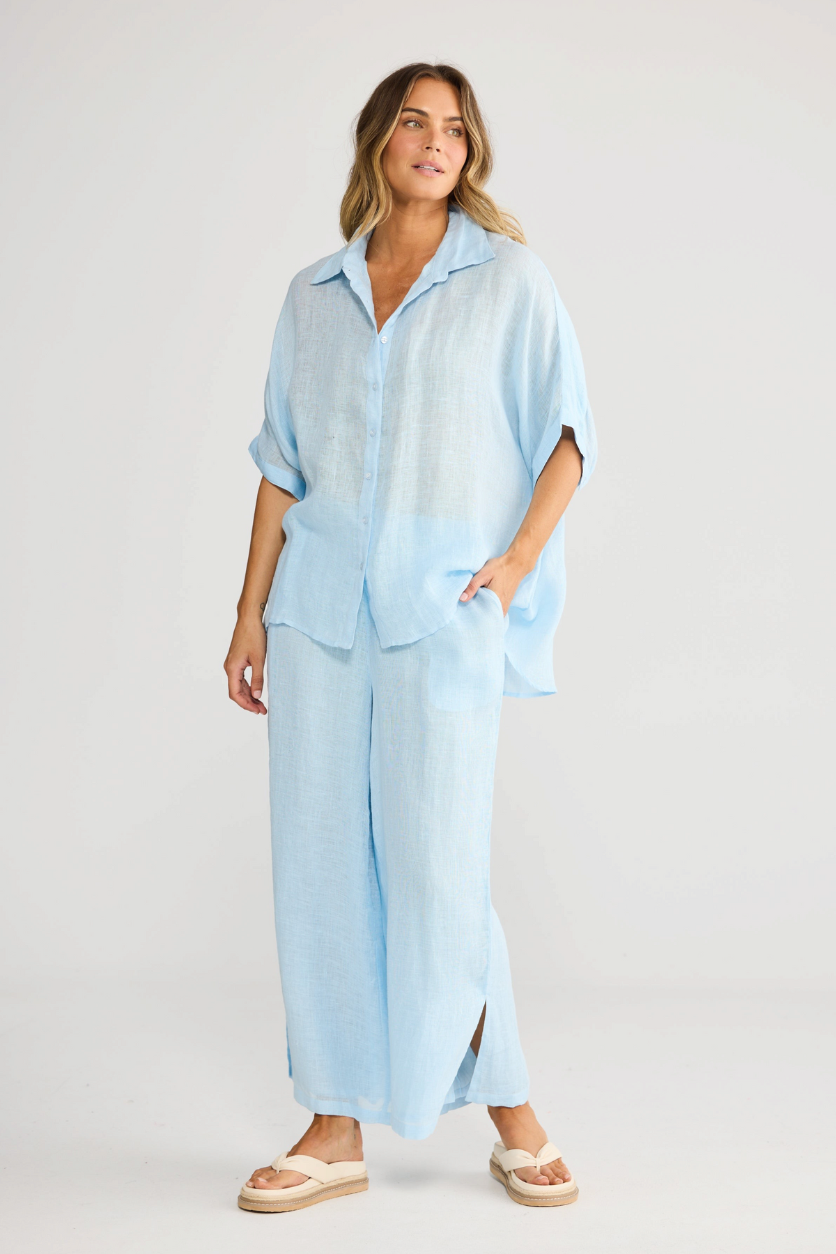 ELSHAM BOUTIQUE light blue oversized linen shirt and matching wide-leg trousers worn by a model in a studio setting.