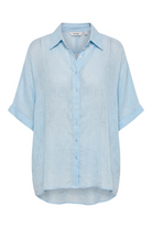 ELSHAM BOUTIQUE light blue oversized linen shirt with a collared neckline, button front, and cuffed short sleeves.