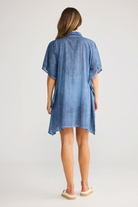 Back view of ELSHAM BOUTIQUE navy cotton shirt kaftan with short sleeves and relaxed fit on a model