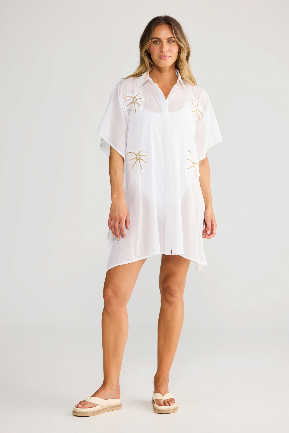 ELSHAM BOUTIQUE white cotton Halia shirt kaftan with short sleeves, button front, and gold starburst embroidery.