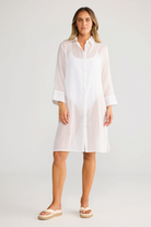 Model wearing ELSHAM BOUTIQUE white cotton shirt dress with concealed button front and short sleeves