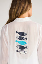 ELSHAM BOUTIQUE white cotton Lilo shirt dress featuring a back panel with beaded fish embroidery in blue and black