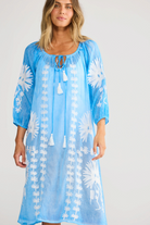 ELSHAM BOUTIQUE blue cotton knee-length Aloha dress with white floral embroidery, tie neckline, and 3/4 sleeves.