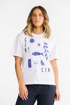 ELSHAM BOUTIQUE white cotton t-shirt with navy blue graphic print of wine, fish, and sun, featuring a round neck.