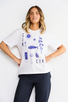 ELSHAM BOUTIQUE white cotton t-shirt with navy blue graphic print, round neck, and short sleeves on a model.
