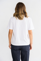 Back view of a woman wearing an ELSHAM BOUTIQUE white cotton short sleeve t-shirt with a regular fit