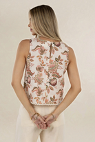 Model wearing ELSHAM BOUTIQUE sleeveless linen top in Bohemian Rose print with scalloped lace hem, back view.