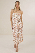 Model wearing ELSHAM BOUTIQUE Bohemian Rose linen midi dress with strappy bodice, scalloped trim, and floral print.