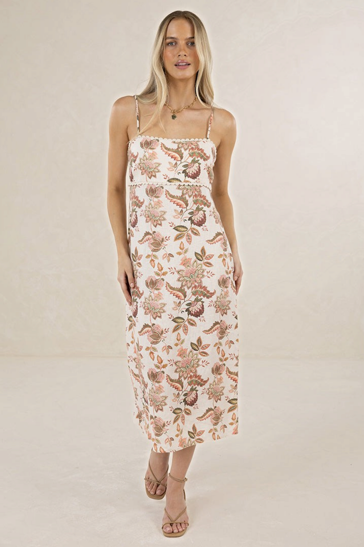 Model wearing ELSHAM BOUTIQUE Bohemian Rose linen midi dress with strappy bodice, scalloped trim, and floral print.