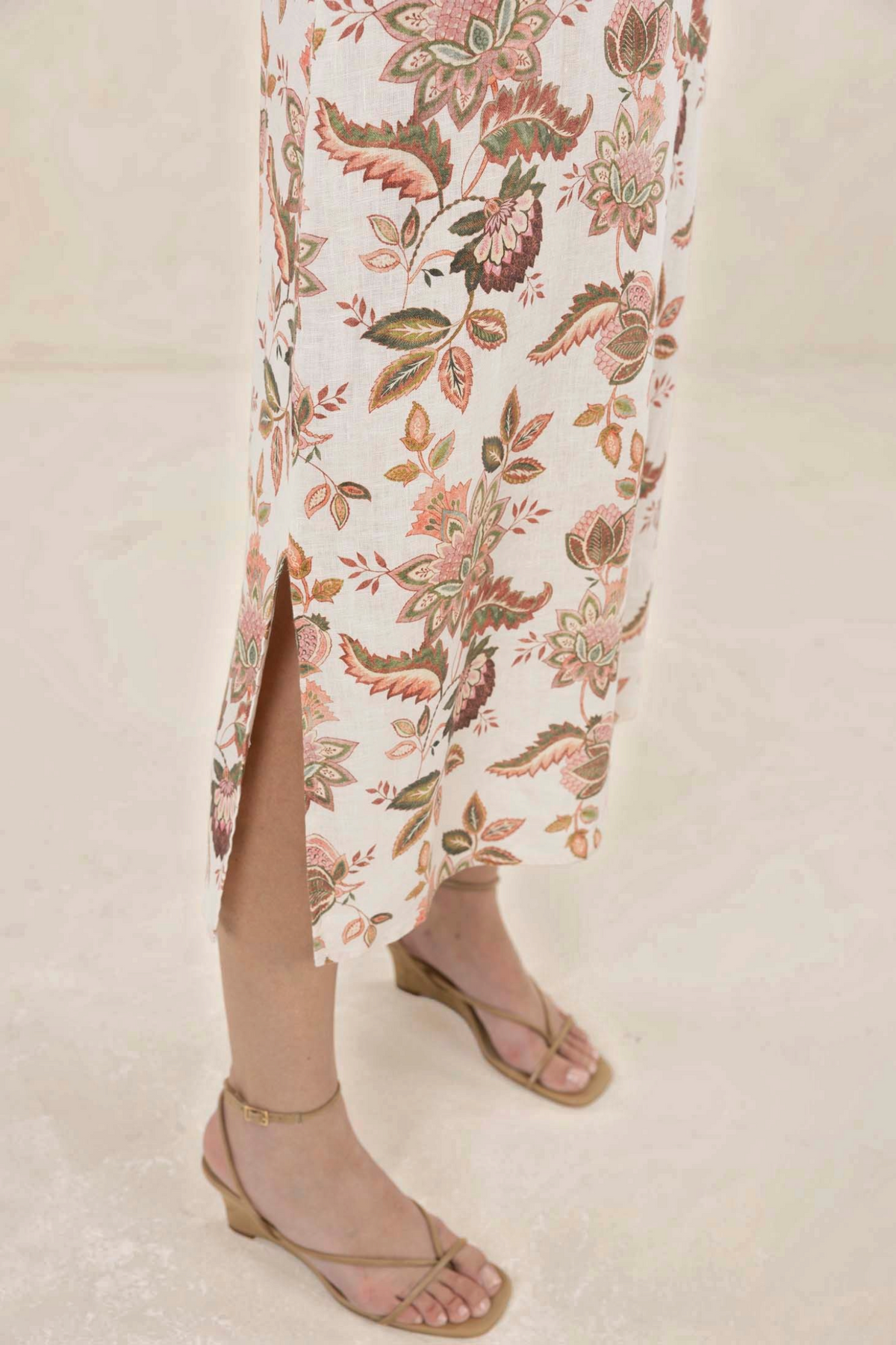 ELSHAM BOUTIQUE Bohemian Rose print linen midi dress featuring a side slit detail and beige strappy wedge sandals.