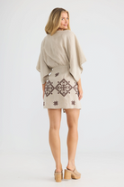 ELSHAM BOUTIQUE natural linen wrap dress with kimono sleeves and brown geometric embroidery, back view