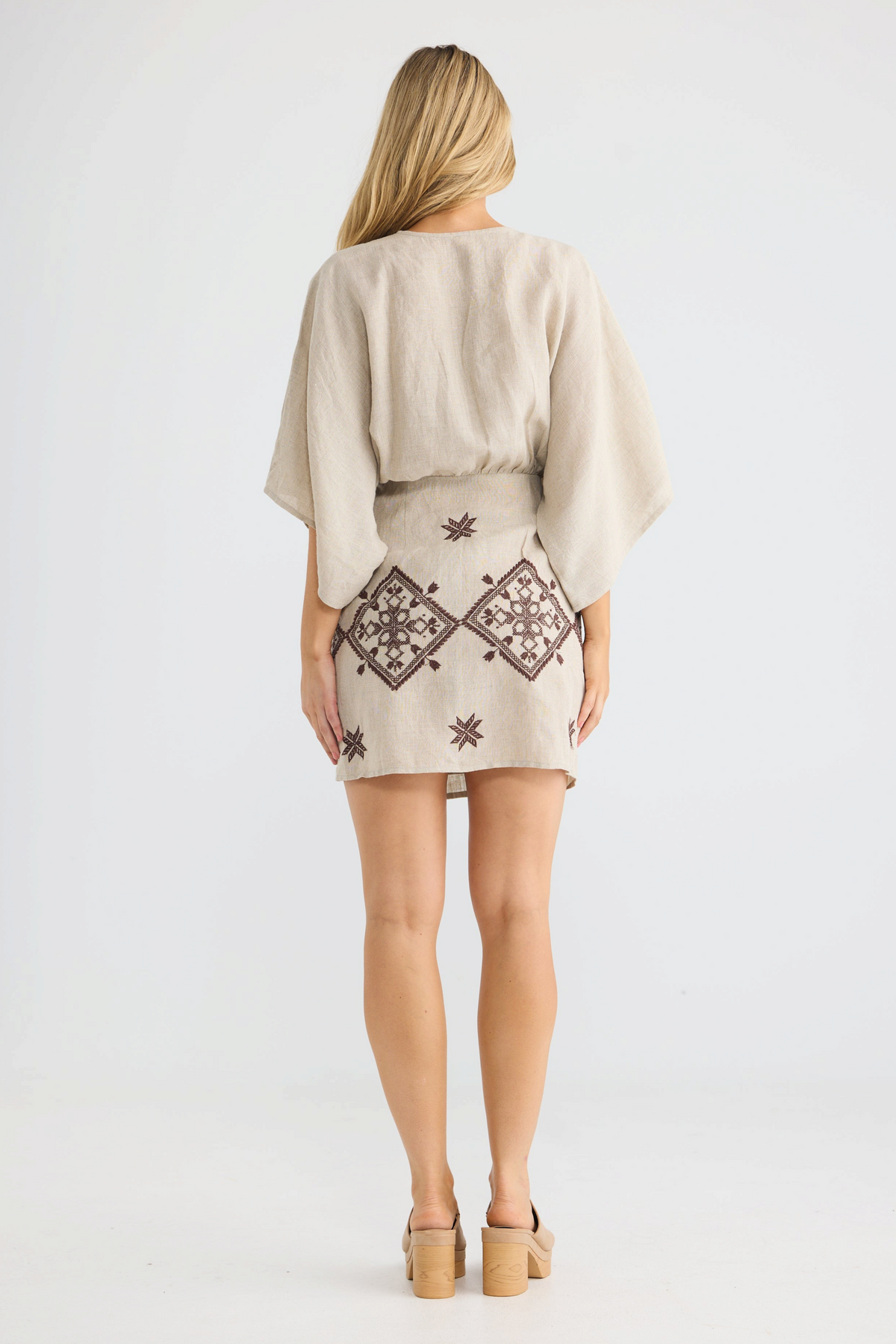 ELSHAM BOUTIQUE natural linen wrap dress with kimono sleeves and brown geometric embroidery, back view.