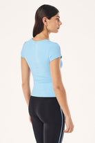 ELSHAM BOUTIQUE Alaskan Blue scoop neck short sleeve top in soft Body Luxe fabric with a slim fit, back view.
