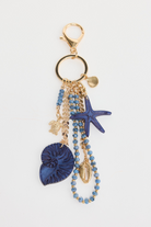 ELSHAM BOUTIQUE blue starfish keyring with shell, bead, and turtle charms on a gold-tone metal clip.