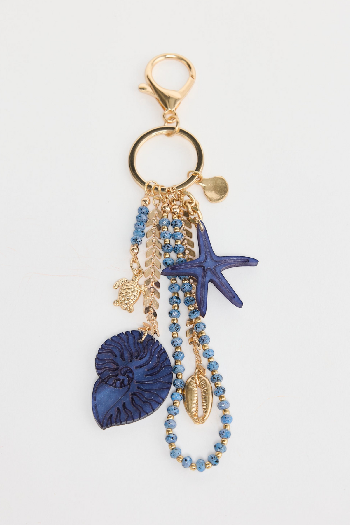 ELSHAM BOUTIQUE blue starfish keyring with shell, bead, and turtle charms on a gold-tone metal clip.