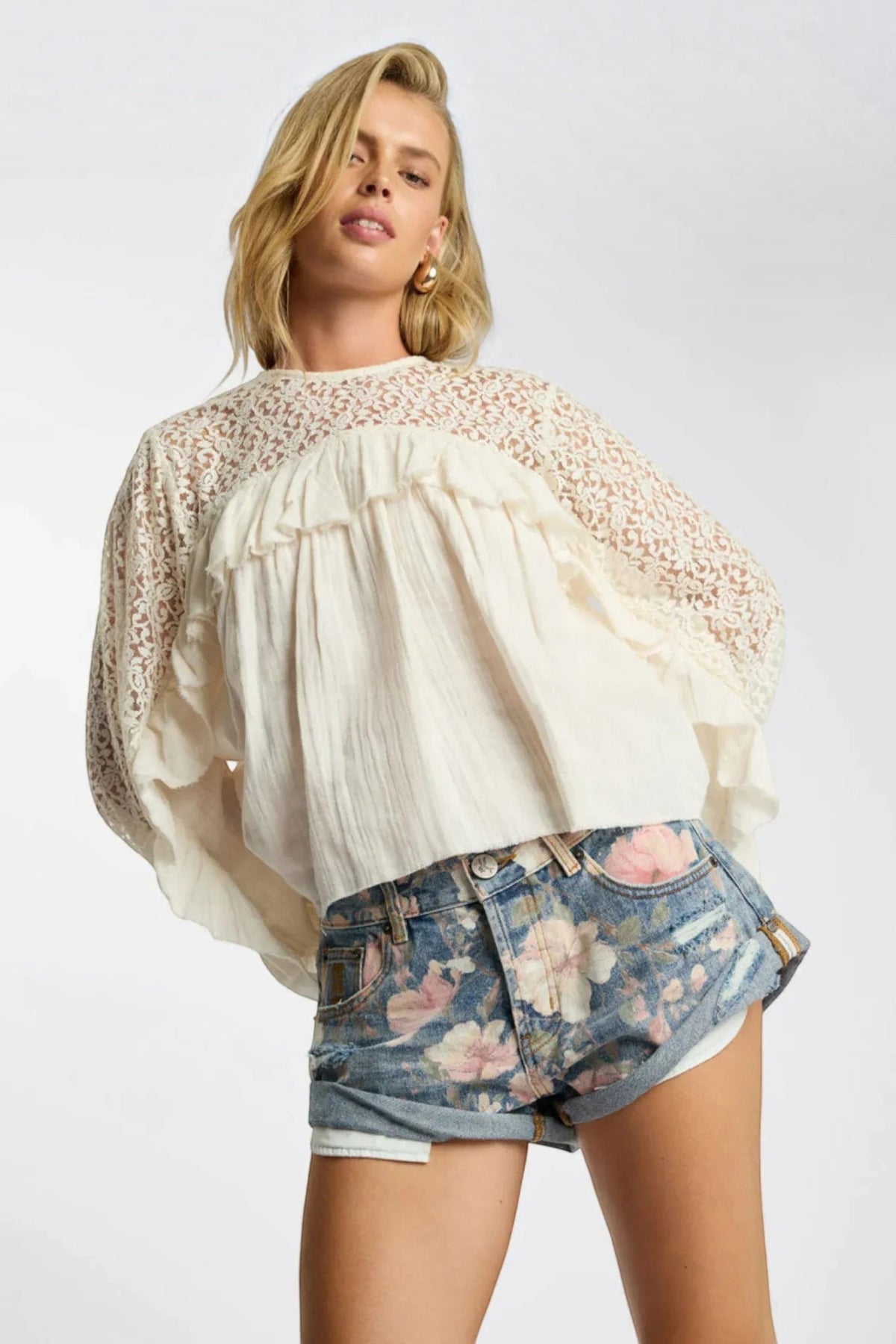 ELSHAM BOUTIQUE low waist denim shorts in floral bloom cobaine blue with patch pockets and rolled hem on a model
