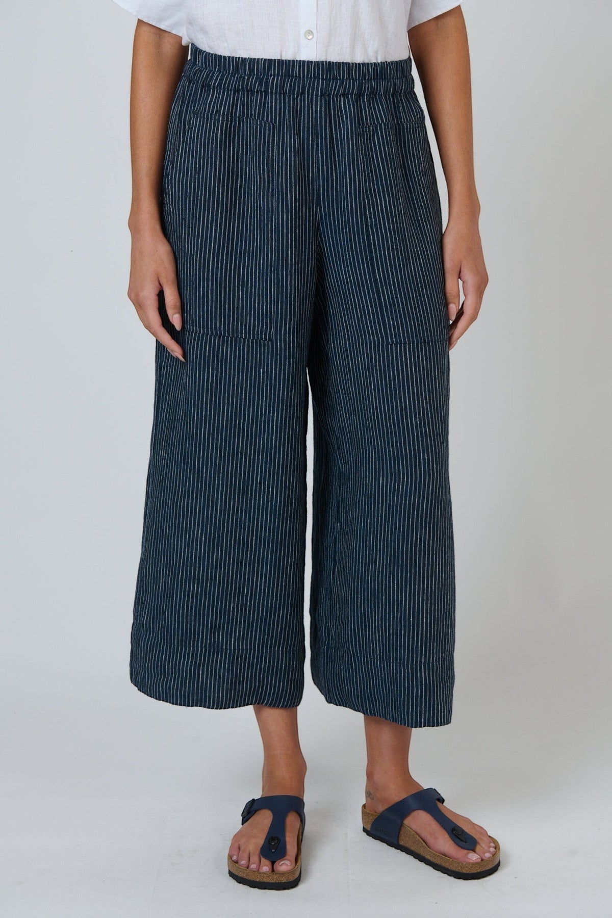 ELSHAM BOUTIQUE navy pinstripe linen wide-leg cropped pants with an elastic waistband and front pockets.