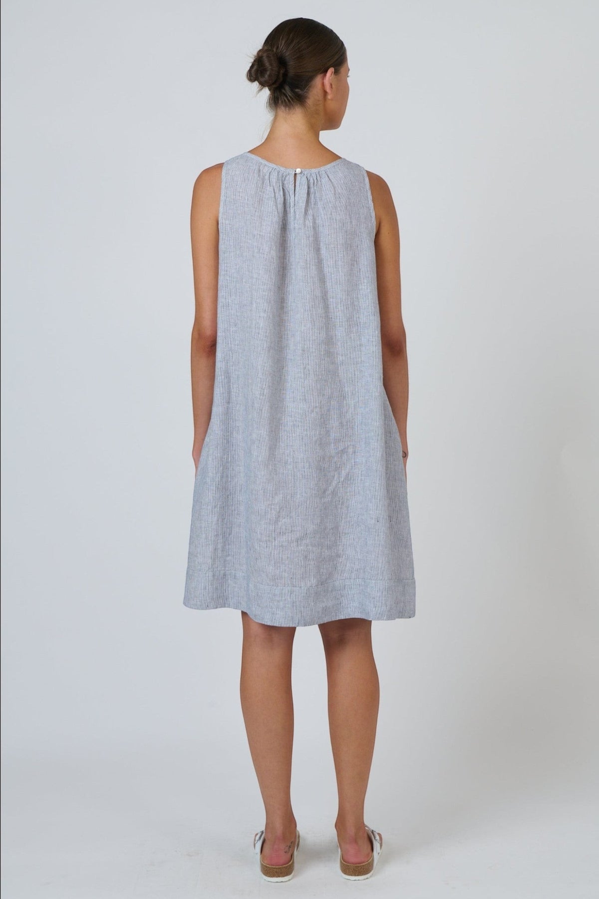 Back view of ELSHAM BOUTIQUE silver linen sleeveless swing dress with gathered neckline and knee-length hem