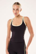 ELSHAM BOUTIQUE Solis Scoop Tank in black bean with soft yellow contrast straps and trim for athletic training.