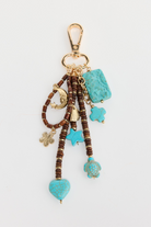 ELSHAM BOUTIQUE Wild West keyring featuring turquoise-look charms, wooden beads, and gold-tone metal accents.