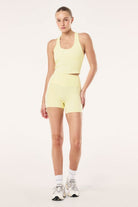 ELSHAM BOUTIQUE soft yellow ribbed racerback tank top with internal shelf bra worn with matching athletic shorts